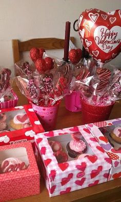 valentine's day desserts and cupcakes are on the table