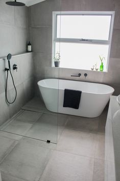 a white bath tub sitting next to a window