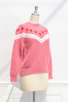 Express your affection in the Heart's Delight sweater! This lovely pullover features a crew neckline, long sleeves, and a sweet pink heart and polka dot pattern. . Details: S: Bust 40", Length 23" M: Bust 42", Length 24" L: Bust 44", Length 25" Length Measured from Shoulder Material: 58% Acrylic, 27% Polyester, 15% Nylon Hand Wash Cold/Flat Dry Imported