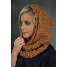 a woman wearing a brown knitted cowl with a hood on her head and hands under her chin