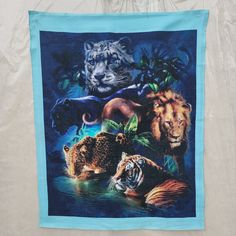 a tea towel with an image of tigers and other animals in the jungle on it