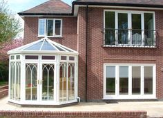 a large brick house with white glass windows