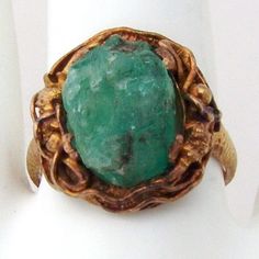 "Vintage Chinese Export ring, made of approx. 20 K (.833) yellow gold. It features dragon figure around the rough Emerald crystal. Band is textured. It is marked \"BO\" and \"JS\" on the inside. This stunning ring is a size 8, 3/4\" at the widest and weighs 5.9 grams. The stone is a little loose, needs to see a jeweler. EA72" Collectible Gold Emerald Ring With Gemstone, Collectible Gold Emerald Gemstone Ring, Gold Emerald Ring Collectible, Asian Dragon Jewelry, Blue Hand-strung Jade Jewelry, Green Multi-stone Gemstones In 14k Gold, Yellow Jade Round Jewelry, Vintage Hand-strung Jade Jewelry, Dragon Ring