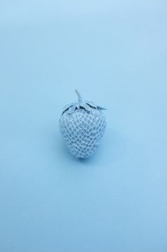 a white strawberries sitting on top of a blue surface