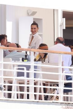 a group of people sitting at tables next to each other