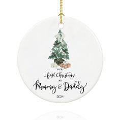 a white ornament with a christmas tree on it and the words first christmas and mommy's & daddy