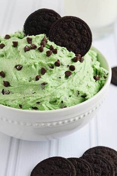 a bowl filled with green ice cream and an oreo cookie