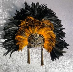 This masquerade mask belongs to our collection of feathers' masks. These masks have a crown of black and colored feathers. It is perfect for any masquerade party, Halloween costume, pro or event in Venice or elsewhere during Carnival. This mask can be gently bent to form to your face and ties in the back with two soft matching ribbons.It is decorated with macrame lace,gold leaf and swarovski. Size: one-size This kind of mask is also perfect as in interior design element, wall decoration. Each ma Black Masks For Carnival Themed Events, Black Masks And Prosthetics For Mardi Gras, Feather Masks For Carnival Costume Party, Black Feather Costume Accessories For Costume Party, Feathered Masks For Carnival Costume Party, Black Feathered Costume Accessories For Costume Party, Black Costume Accessories For Mardi Gras Carnival, Black Mardi Gras Carnival Costume Accessories, Feathered Masks For Masquerade Carnival