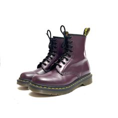 Vintage Y2K purple leather 8-eye 1460 lace up combat boots by Dr. Martens. Features dark purple leather uppers, rounded toe, 8-eye lace up fronts, combat style, above-ankle rise, flat tops, pull on loop at center back, classic yellow welt stitching, thick chunky sole, and short block heel. Excellent vintage condition.   Heel to toe (inside shoe): 9.625 inches  Ball of foot (bottom of sole): 4.125 inches  Heel height: 1.125 inches  Rise: 6.375 inches  Size 7 Purple Leather Lace-up Boots, Purple Lace-up Leather Boots, Purple Lace-up Boots For Streetwear, Purple Round Toe Boots For Streetwear, Combat Style, Inside Shoes, Lace Up Combat Boots, Milwaukee Wi, Purple Leather