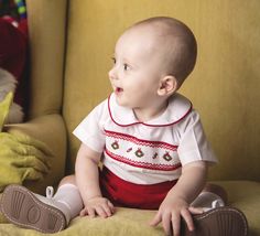 "He will have that sweet look you love in a smocked Christmas outfit by Zuli Kids. Christmas outfit for baby boy is a button-on baby boy romper in red baby cord fabric pant with peter pan collar white shirt. Shirt has smocked design in Christmas wreaths. We only have a few with white piping in collars. Most of them have red piping. If you have a preference, please let us know at them time of order and we will do our best to give you the style you desire. This is a beautiful baby boy clothes choi Boy Christmas Outfit, Christmas Photos Outfits, Smocked Baby Clothes, 1st Birthday Outfit Girl, Baby Boy Christmas Outfit, Toddler Christmas Outfit, Baby Easter Outfit, Toddler Christmas Dress