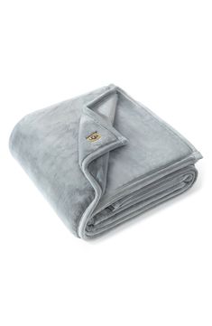 the grey blanket is folded on top of it