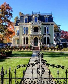 a large house with an iron gate in front of it