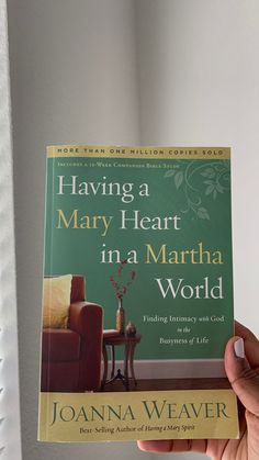 a person holding up a book about having a mary heart in a martha world