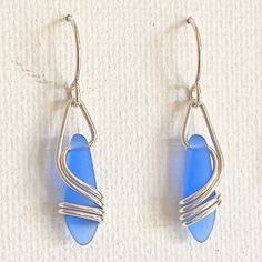 "This earring is a BEST SELLER ~ I use 20 gauge, sterling silver wire ~ which gracefully flows down & around the matte glass. This is NOT beachglass, rather they are pressed beads from the czech republic. The glass does, however, look very much like beachglass They hang 1 1/4\" x 1/4\" and are very light and super comfortable! A great, everyday earring at a great price ~ BEST SELLER 10 years & counting! Arrives, thoughtfully gift packaged on CRD printed earring card & artisan bio ~ c Nickel-free Teardrop Earrings In Recycled Glass, Nickel-free Teardrop Earrings Made Of Recycled Glass, Teardrop Sea Glass Earrings With Ear Wire, Adjustable Nickel-free Sea Glass Earrings, Adjustable Nickel Free Sea Glass Earrings, Nickel-free Adjustable Sea Glass Earrings, Nickel-free Sea Glass Earrings For Jewelry Making, Nickel-free Silver Earrings In Recycled Glass, Nickel-free Silver Earrings With Recycled Glass