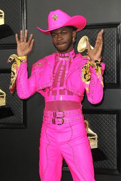 a male in a pink suit and cowboy hat