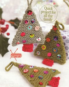 two crocheted christmas trees with buttons on them