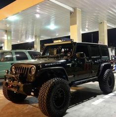 a jeep is parked in front of a gas station