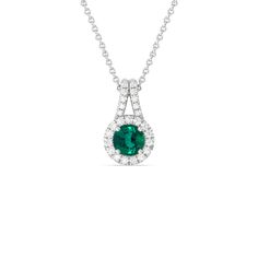 The refined elegance of this gemstone pendant allows you to elevate the look of any outfit in an instant. The pendant features a Round Shape Emerald on its center framed by a classic halo of lab-grown diamonds. A diamond-studded split bale holds the halo-wrapped colored gem.