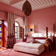 a bedroom with pink walls and red carpet