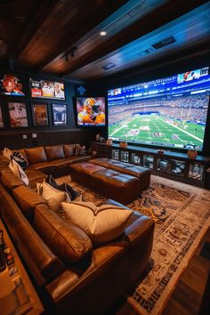 a living room with two couches and a large screen tv on the wall behind it