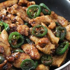 chicken and peppers in a skillet with brown sauce on the side, ready to be eaten