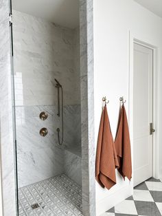 two towels hanging on the wall in a bathroom