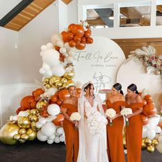 the bride and her bridesmaids are posing in front of an assortment of balloons