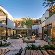 an outdoor courtyard with wooden benches and tables