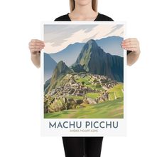 a woman holding up a poster with machu picchu on it