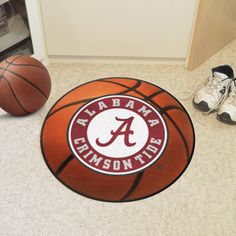 a basketball sitting on the floor next to a pair of shoes and a shoe rack