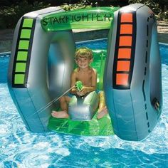 an inflatable water slide with a young boy on it and the words starfighter above