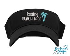 "Save 20% off your first purchase by signing up at https://signup.sewvividdesigns.com This lightweight and comfortable visor features Resting BEACH Face with a palm tree embroidered on your choice of visor. For more font options, send me a message and we will find the perfect font for you! Visor featured in photo: Black Starfish Color in photo: Aqua 🧢 Visor Details 🧢 -One size fits most -Pre-curved visor -100% cotton -Hook and loop adjustable closure (Velcro) -Visor panel height 2.25\" -Visor Cheap Visor Bucket Hat For Beach, Cheap Adjustable Fitted Hat With Curved Visor, Cheap Classic Snapback Hat With Visor, Affordable Classic Snapback Hat With Visor, Cheap Outdoor Dad Hat With Curved Visor, Cheap Black Fitted Hat With Curved Visor, Cheap Snapback Visor Hat For Streetwear, Cheap Black Fitted Hat With Visor, Cheap Beach Snapback Visor Hat