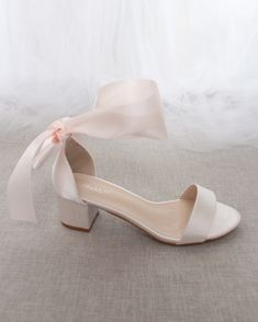 Classy satin block heel with satin ribbon ankle tie. Simple yet elegant are great combination and will definitely be a favorite.DETAILS:HEEL HEIGHT: 1.25 inches (kids) & 2 inches (women)RIBBON WIDTH: 1.5 inchesUPPER: Synthetic upper and liningMATERIALS: Manmade outsoleORIGIN: Imported Bridal Flat Sandals, White Shoes Heels, Ribbon Sandals, Bridesmaids Shoes, Women's Slip Ons, Bridal Sandals, Bridesmaid Shoes, Bow Flats, Bow Shoes