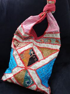 Mirror-work women's sling bag with patchwork & embroidery. A colourful ethnic shoulder bag from India for women. Unique, classy day or evening hand bag. Take patches of colourful cloth. Add interesting embroidery of sequins and stones and beads. Add some more colourful stitches with contrasting colour thread. Mix and match the patches and hand stitch them with a colourful beading. Add handles. Voila! You have a tote bag that is so unique that there just cannot be another one such, anywhere i Indian Bags, Indian Sandals, University Bag, Ipad Pouch, Patchwork Embroidery, Womens Sling Bag, Ethnic Bag, Ipad Bag, Sequin Bag