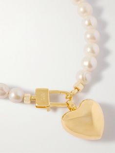 Martha Calvo's necklace takes an innocent approach to romance. It’s strung with lustrous freshwater pearls and centered with a gold-plated heart-shaped pendant, which can also be removed if you want a simpler look. Gold Pearl Necklace, Fashion Jewelry Necklaces, Gold Plated Jewelry, Jewelry Plate, Fashion Bracelets, Fashion Earrings, Fashion Watches, Crystal Necklace, Womens Jewelry Necklace