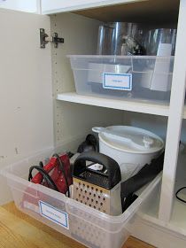 an organized pantry with plastic containers and tools