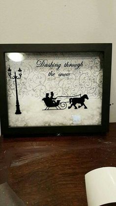 a black and white picture frame with a couple riding in a sleigh under a street light