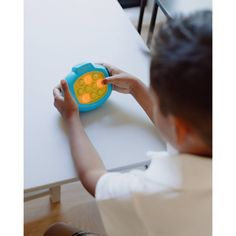 a child is playing with a toy on the table