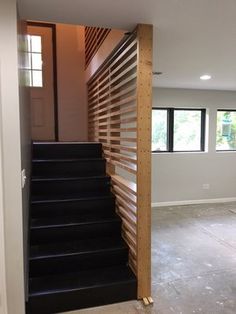 an empty room with stairs leading up to the second floor