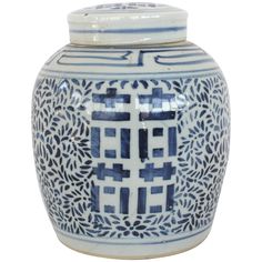 a blue and white vase with an intricate design on the front, sitting against a white background