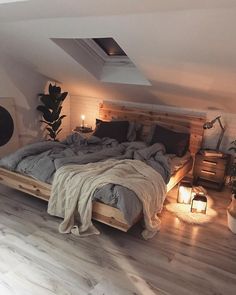 a bedroom with a bed made out of wood and lights on the side of it