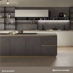 a modern kitchen with marble counter tops and cabinets