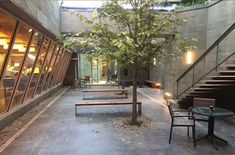 an empty courtyard with benches, tables and stairs