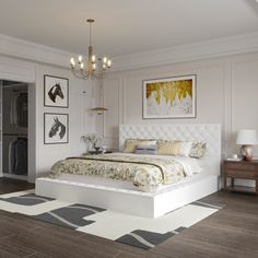 a bedroom with a bed, chandelier and pictures on the wall