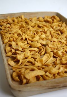 a pan filled with tortilla chips on top of a table