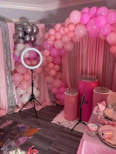 a party room with pink and silver balloons