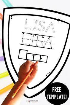 a child's hand holding a pencil and drawing a shield with the word usa on it