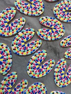 colorfully decorated cookies sitting on top of a table