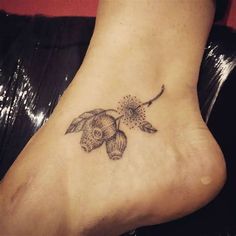 a tattoo on the foot of a woman's foot with an image of a flower