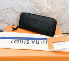 Authentic Louis Vuitton Empreinte Clemence black leather zip wallet. This wallet is crafted of monogram embossed calfskin leather in black. The polished brass wrap-around zipper opens to a partitioned black leather interior with card slots, patch pockets, and a zipper compartment. Excellent condition. Includes dust bag only. Measures approx 7.75”x3.5”x1”. Louis Vuitton Empreinte, Zip Wallet, Leather Interior, Polished Brass, Authentic Louis Vuitton, Patch Pocket, Card Slots, Calf Skin, Slots